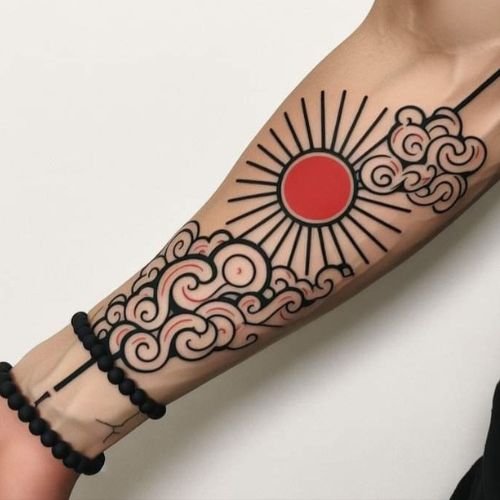 Japanese-style sun and cloud tattoo designed on the hand, showcasing traditional Japanese tattoo art at Dark Shader Tattoo shop in Kolkata.