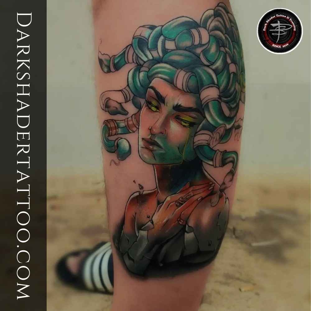 A unique tattoo of a girl with green hair made of snakes, designed on a girl’s neck. these types of tattoo are strong tattoos for girls