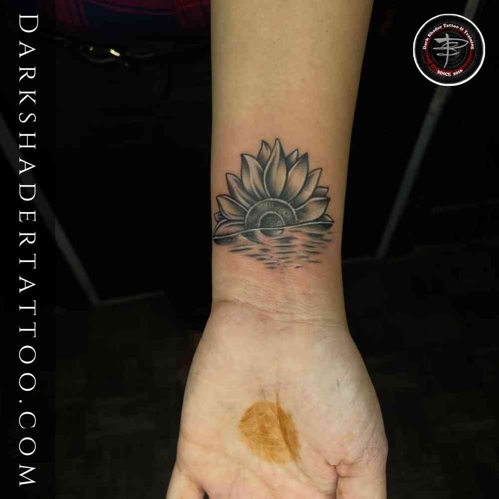 A simple sunflower tattoo on a girl’s wrist, perfect for small tattoos for girls.