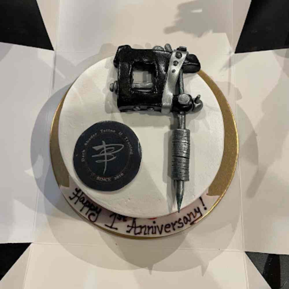 Dark shader tattoo anniversary cake. Designed a tattoo machine designed on cake.