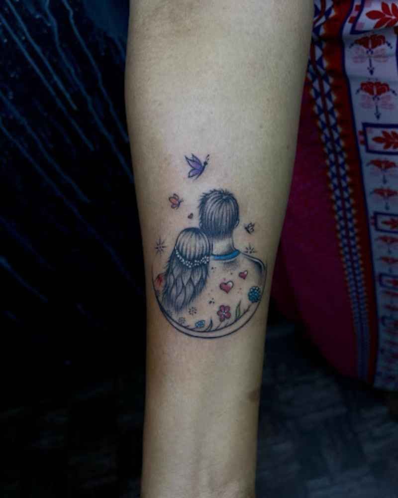 A beautiful tattoo design showing a girl's head on a boy's shoulder with colorful butterflies and love symbols, located on the hand. Perfect for lovers.