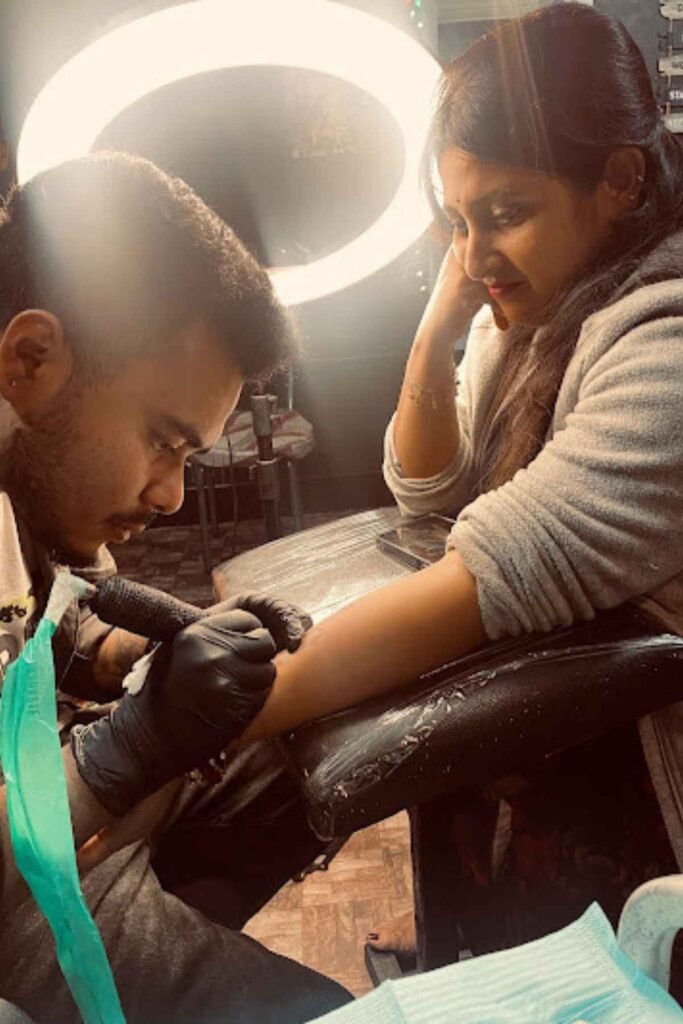 Souvik Das designing a tattoo peacefully at Dark Shader Tattoo in Kolkata, known for calm and precise artistry.