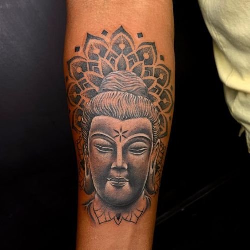 Calm buddha face with closed eyes and dotwork design on background. Designed on wrist created in dark shader tattoo on of the best tattoo parlour in kolkata.