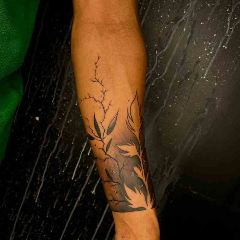 A detailed hand tattoo design featuring a leaf and lightning with dark shading, created by expert tattoo artists at Dark Shader Tattoo in Kolkata.