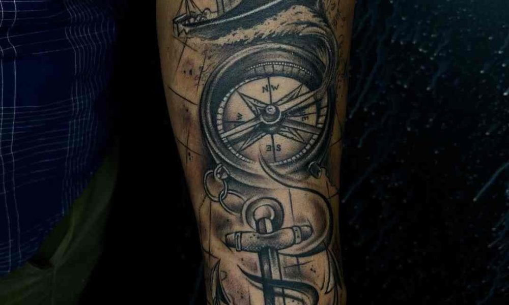 wrist tattoo with compass ship and anchor design